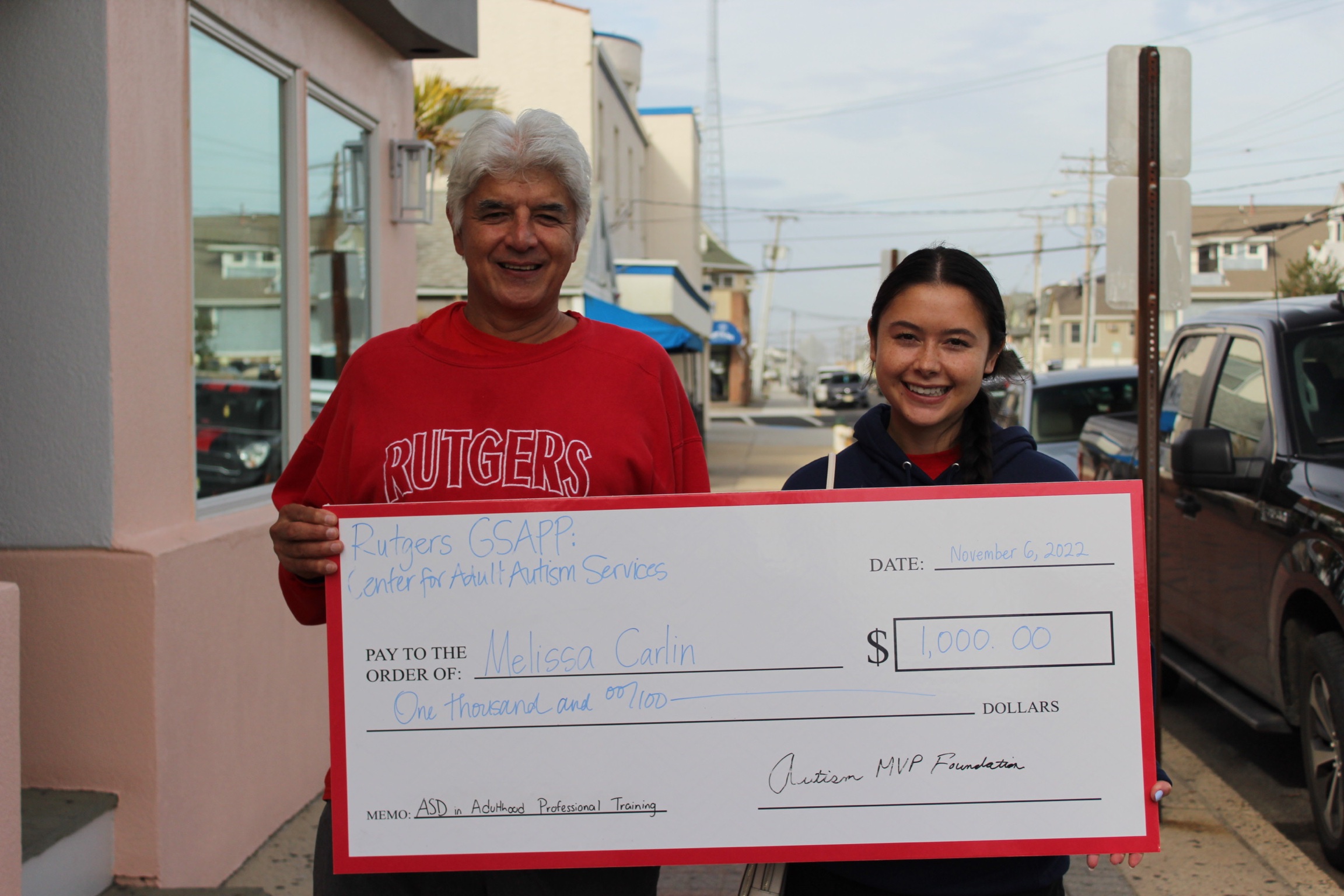 Rutgers U Melissa Carlin with Dad Autism MVP Check